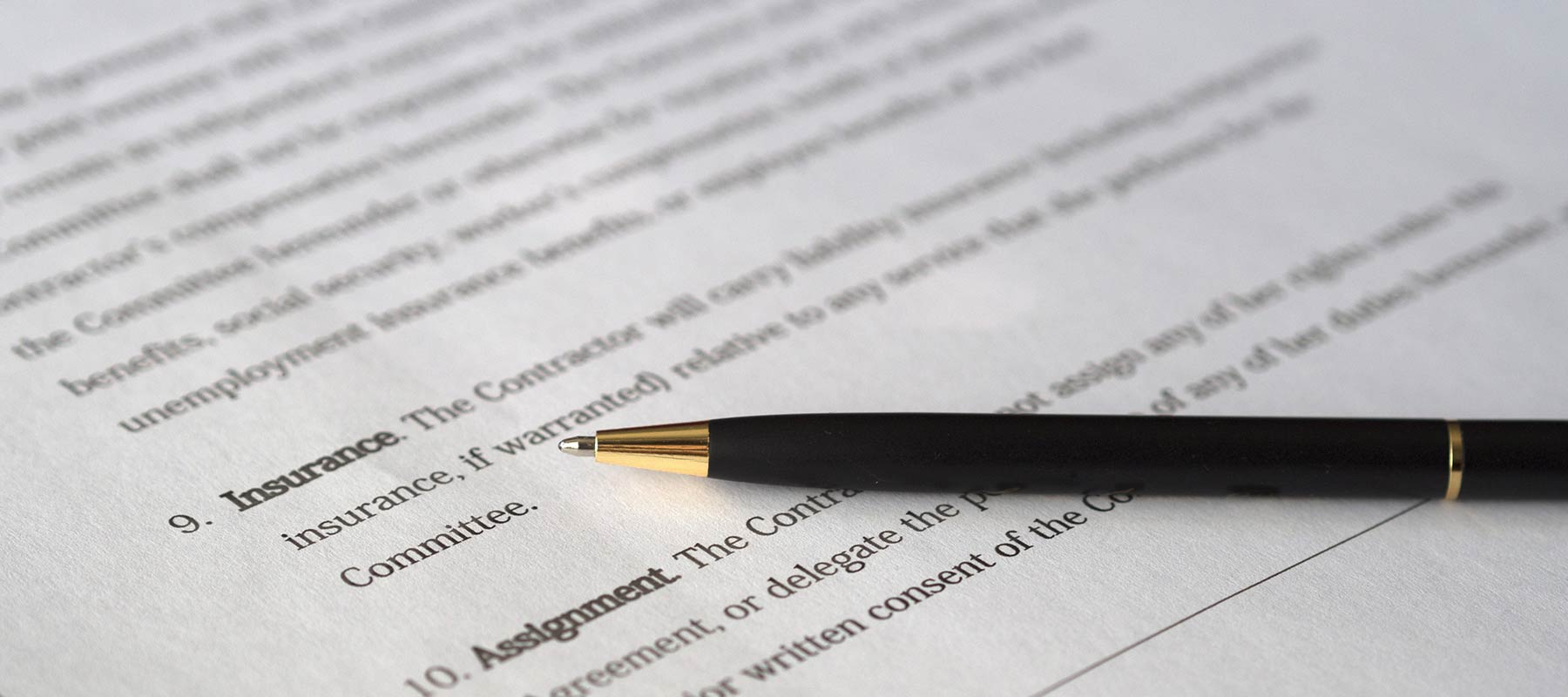 Photo of a contract and a pen
