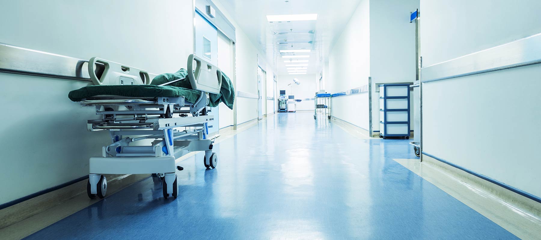 Photo of a hospital hallway with gurney