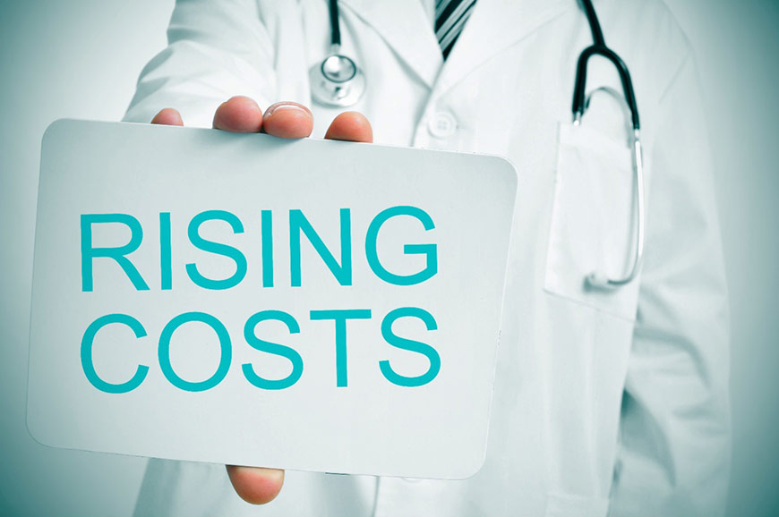 Photo of a doctor holding a sign that says Rising Costs